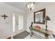 Bright entryway with glass-paned door, decorative mirror, and console table at 5 Pinehurst Ct, Rotonda West, FL 33947