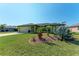 Landscaped front yard with agave plants and a view of the house's facade at 5 Pinehurst Ct, Rotonda West, FL 33947