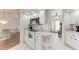 White kitchen with stainless steel appliances and view to dining room at 5 Pinehurst Ct, Rotonda West, FL 33947