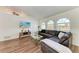 L-shaped sectional sofa dominates this living room with wood-look floors and large windows at 5 Pinehurst Ct, Rotonda West, FL 33947