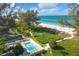 Aerial view of community pool, tennis courts, and beach access at 5055 Gulf Of Mexico Dr # 424, Longboat Key, FL 34228