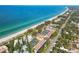 Aerial view showing beachfront property, tennis courts, and pool at 5055 Gulf Of Mexico Dr # 424, Longboat Key, FL 34228