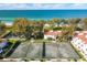 Aerial view of condo community with tennis courts near beach at 5055 Gulf Of Mexico Dr # 424, Longboat Key, FL 34228