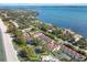 Wide aerial view of beachfront property with tennis courts and resort style pool at 5055 Gulf Of Mexico Dr # 424, Longboat Key, FL 34228