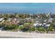 Aerial view showcasing beachfront community, pool, and tennis courts at 5055 Gulf Of Mexico Dr # 424, Longboat Key, FL 34228