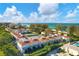 Aerial view of condo community near beach, featuring tennis courts and pool at 5055 Gulf Of Mexico Dr # 424, Longboat Key, FL 34228