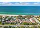 Aerial view of beachfront community with tennis courts and pool at 5055 Gulf Of Mexico Dr # 424, Longboat Key, FL 34228