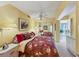 Bedroom with floral bedding, mirrored closet, and access to a balcony at 5055 Gulf Of Mexico Dr # 424, Longboat Key, FL 34228