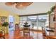 Dining room with glass table and chairs, overlooking a balcony at 5055 Gulf Of Mexico Dr # 424, Longboat Key, FL 34228