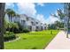 Exterior view of building showcasing balconies and green space at 5055 Gulf Of Mexico Dr # 424, Longboat Key, FL 34228