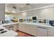 White kitchen with ample counter space and a breakfast bar at 5055 Gulf Of Mexico Dr # 424, Longboat Key, FL 34228