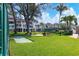 Community lawn with shuffleboard and partial building view at 5055 Gulf Of Mexico Dr # 424, Longboat Key, FL 34228