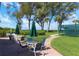 Seating area with tables and umbrellas near tennis courts at 5055 Gulf Of Mexico Dr # 424, Longboat Key, FL 34228