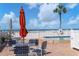 Relaxing pool area with patio furniture and beach view at 5055 Gulf Of Mexico Dr # 424, Longboat Key, FL 34228