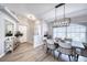 Elegant dining room featuring a wood table, modern chandelier, and hardwood floors at 5117 19Th E Ln, Bradenton, FL 34203