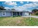 House exterior with a covered porch, lawn, and garage at 5117 19Th E Ln, Bradenton, FL 34203