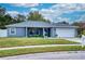 Newly renovated one-story home with gray exterior, landscaped lawn, and attached garage at 5117 19Th E Ln, Bradenton, FL 34203