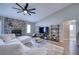 Living room with stone fireplace, sectional sofa, and built-in shelving at 5117 19Th E Ln, Bradenton, FL 34203