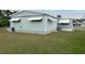 Single-wide mobile home with awnings and landscaping at 5327 Glen Echo Ave, Sarasota, FL 34234