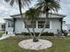 Landscaped front yard with a gray mobile home at 5327 Glen Echo Ave, Sarasota, FL 34234