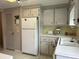 Kitchen with white appliances and light wood cabinets at 5327 Glen Echo Ave, Sarasota, FL 34234