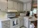 Galley kitchen with white appliances and light wood cabinets at 5327 Glen Echo Ave, Sarasota, FL 34234