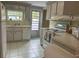 Efficient kitchen, white appliances, light wood cabinets at 5327 Glen Echo Ave, Sarasota, FL 34234