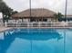 Community pool with tiki hut and lounge chairs at 5327 Glen Echo Ave, Sarasota, FL 34234