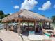 Relax under a thatched-roof tiki hut by the pool at 5327 Glen Echo Ave, Sarasota, FL 34234