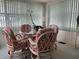 Relaxing sunroom with a glass-top table and four chairs at 5327 Glen Echo Ave, Sarasota, FL 34234