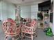 Bright sunroom boasts a table for four and additional seating at 5327 Glen Echo Ave, Sarasota, FL 34234