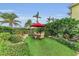 Landscaped backyard with artificial turf and patio furniture at 550 Yardarm Ln, Longboat Key, FL 34228