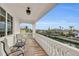 Private balcony overlooking waterfront with seating area at 550 Yardarm Ln, Longboat Key, FL 34228