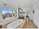 Luxurious bathroom with soaking tub and water views at 550 Yardarm Ln, Longboat Key, FL 34228