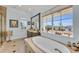 Elegant bathroom with soaking tub and large window at 550 Yardarm Ln, Longboat Key, FL 34228