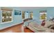 Bright bedroom with wood floors, large windows, and a comfortable bed at 550 Yardarm Ln, Longboat Key, FL 34228