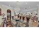 Elegant dining room featuring a large glass table, chandelier, and wine storage at 550 Yardarm Ln, Longboat Key, FL 34228