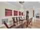 Formal dining room features a glass-top table, chandelier, and wine storage at 550 Yardarm Ln, Longboat Key, FL 34228