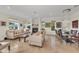 Elegant dining room with large glass table and chandelier at 550 Yardarm Ln, Longboat Key, FL 34228