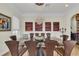 Formal dining room with glass table and modern chandelier at 550 Yardarm Ln, Longboat Key, FL 34228