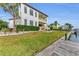 Two-story home with manicured lawn and dock at 550 Yardarm Ln, Longboat Key, FL 34228