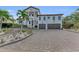 Two-story house with a large driveway and landscaping at 550 Yardarm Ln, Longboat Key, FL 34228