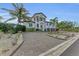 Mediterranean-style home with palm trees and a brick driveway at 550 Yardarm Ln, Longboat Key, FL 34228