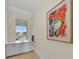 Light and airy hallway with large window and built-in cabinets at 550 Yardarm Ln, Longboat Key, FL 34228