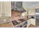 Stainless steel gas cooktop and range hood in a large kitchen at 550 Yardarm Ln, Longboat Key, FL 34228