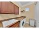 Laundry room with washer, dryer, and utility sink at 550 Yardarm Ln, Longboat Key, FL 34228