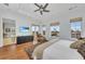 Main bedroom with hardwood floors, water views and ensuite bathroom at 550 Yardarm Ln, Longboat Key, FL 34228