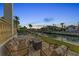 Waterfront patio with fire pit and seating at 550 Yardarm Ln, Longboat Key, FL 34228