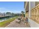 Waterfront patio with fire pit and seating at 550 Yardarm Ln, Longboat Key, FL 34228