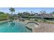 Inviting pool and spa overlooking a canal at 550 Yardarm Ln, Longboat Key, FL 34228